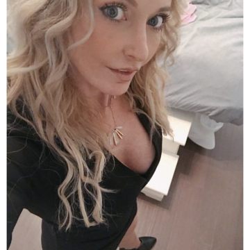 Screenshot of Bumble app showing a woman with blonde hair in a black top, part of her face and upper body visible.